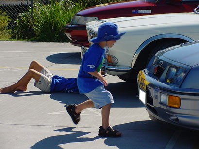 Thoroughly inspecting the classic cars on display